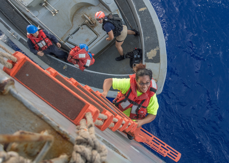 Tasha Fuiaba, an American mariner who had been sailing for five months on a damaged sailboat, climbs the accommodation ladder to board the amphibious dock landing ship USS Ashland. (U.S. Navy photo by Mass Communication Specialist 3rd Class Jonathan Clay/Released)